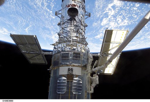 EVA 3 - Linnehan and Grunsfeld install new PCU