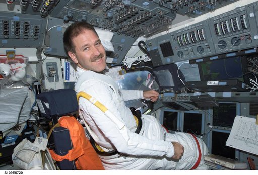 MS Grunsfeld at commander's station on forward flight deck