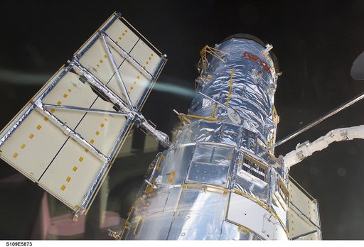 HST removed from payload bay by RMS arm