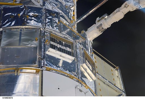 HST removed from payload bay by RMS arm