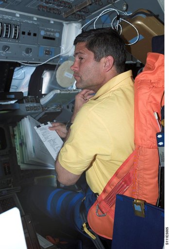 Lockhart reviews a checklist from the PLT's seat on Shuttle Endeavour's FD during STS-111 UF-2