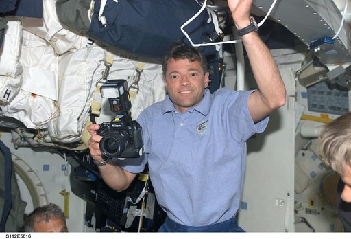 STS-112 CDR Ashby on middeck with camera