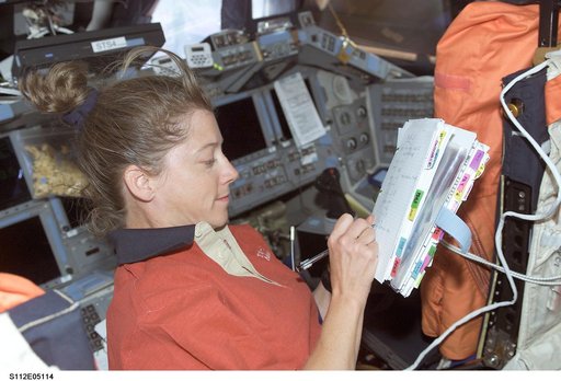 STS-112 PLT Melroy with checklist on flight deck