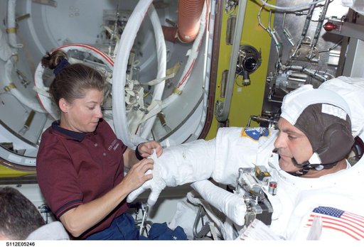 MS Wolf prepares for EVA 2 with help from PLT Melroy
