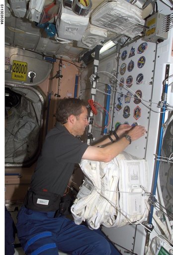 Wetherbee places mission sticker on panel in Node 1 during STS-113 / EXP. 5