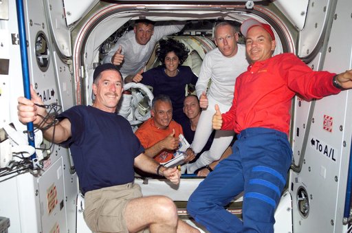 STS-117 and Expedition 15 Crew posing for camera in the Quest A/L during Joint Operations