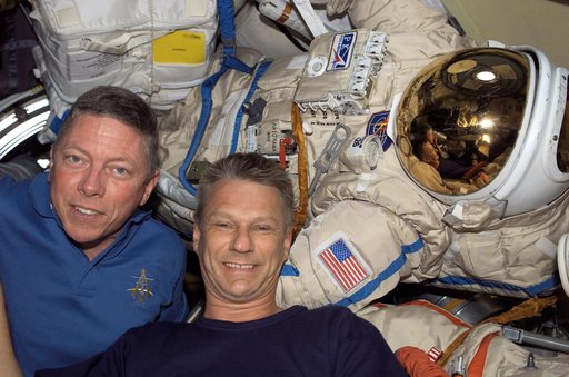 Fossum and Sellers with Orlan Suit inside the DC during STS-121 / Expedition 13 joint operations
