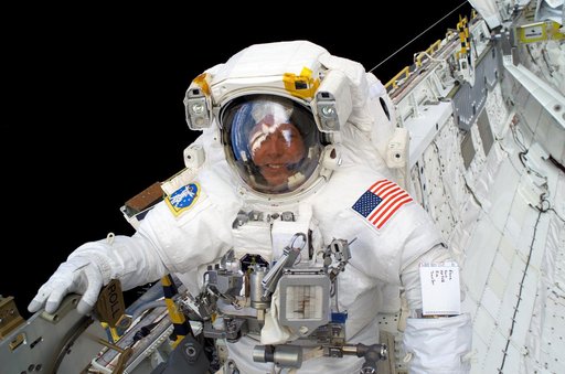 Fossum smiles at the camera during EVA3 on STS-121 / Expedition 13 joint operations