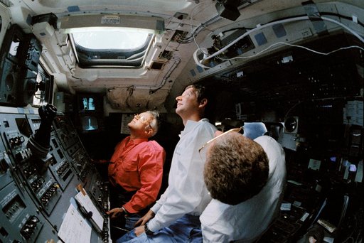STS-31 crew monitors Hubble Space Telescope (HST) from OV-103's flight deck