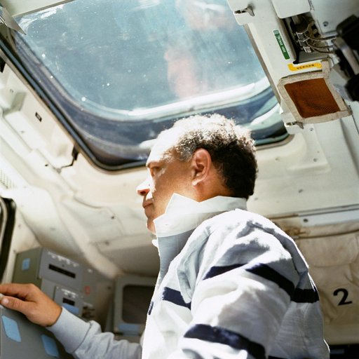 STS-33 Commander Gregory looks through window on OV-103's aft flight deck