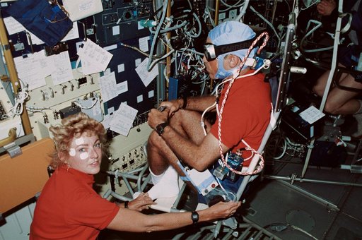 STS-40 crewmembers, working in SLS-1 module, conduct Experiment No. 072
