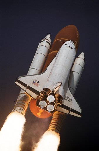 STS-45 Atlantis, OV-104, begins its roll maneuver after liftoff from KSC