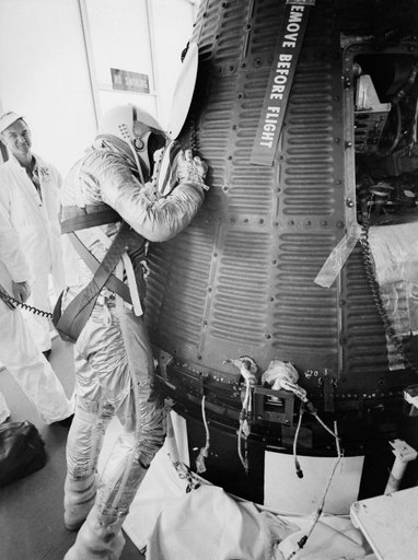Astronaut Alan Shepard in pressure suit with Freedom 7 capsule