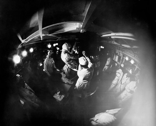 Fish-eye view of Astronaut John Glenn insertion into the Mercury Spacecraft