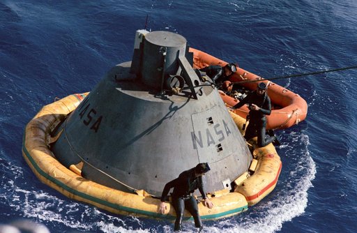 Frogmen on Apollo command module boilerplate flotation collar during recovery