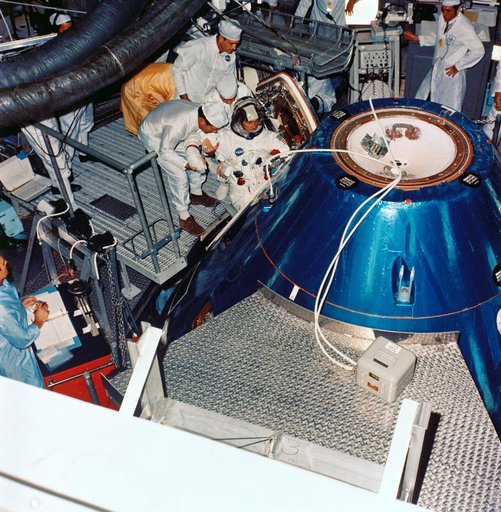 Astronaut John Young ingresses Apollo spacecraft command module in training