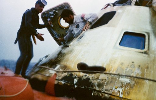 Astronaut Walter Schirra egresses spacecraft during recovery operations