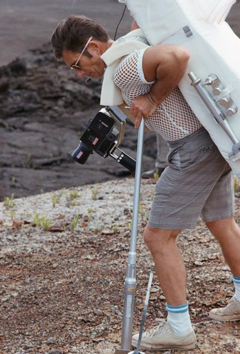 Astronaut James Irwin simulates using lunar surface geological tools