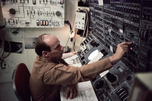 Astronaut Charles Conrad Jr. working with control panel in Skylab simulation