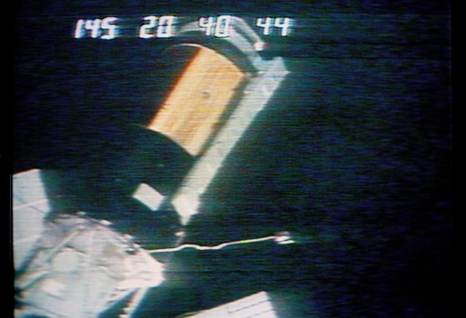 View of the Skylab 1 space station cluster from the Skylab 2 Command Module