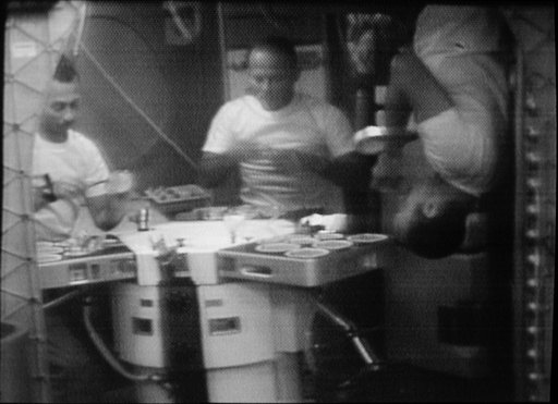 Skylab 3 crewmen shown eating in Orbital Workshop wardroom