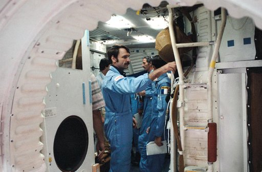STS 51-E crew is briefed on the Shuttle full fuselage trainer