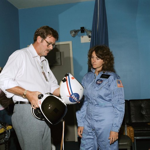 Payload specialist Christa McAuliffe briefed on launch/entry helmets