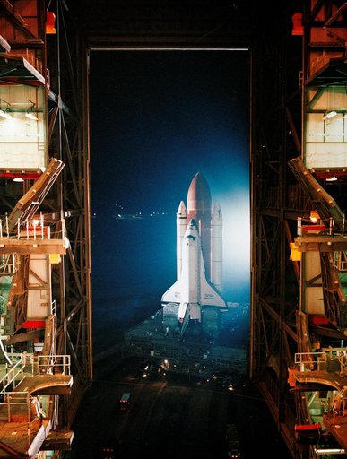 STS-26 Discovery, OV-103, rolls out of KSC VAB into darkness of the night