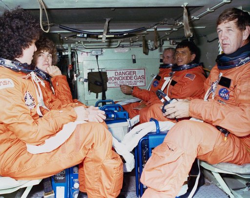 STS-34 crewmembers sit in M1-13 APC during emergency egress training at KSC