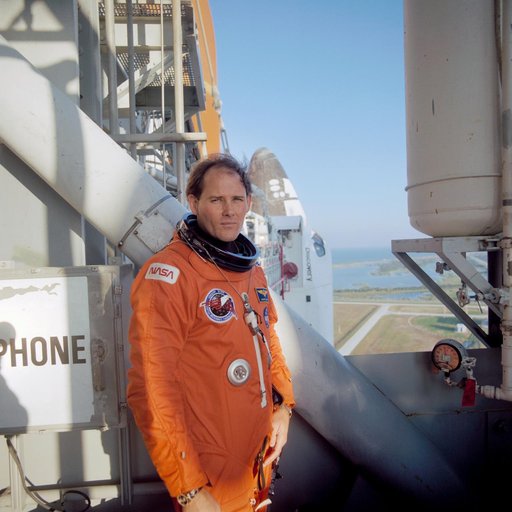 STS-33 MS Carter on KSC LC Pad 39B 195 ft level with OV-103 in background