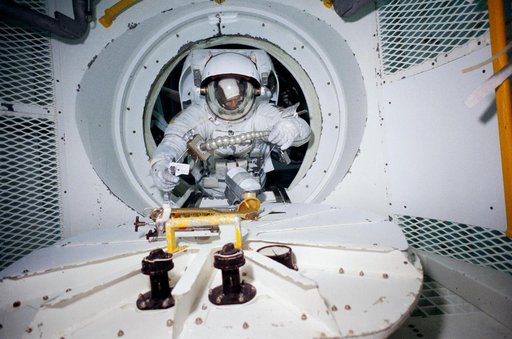 STS-31 MS Sullivan exits airlock mockup during JSC WETF underwater simulation