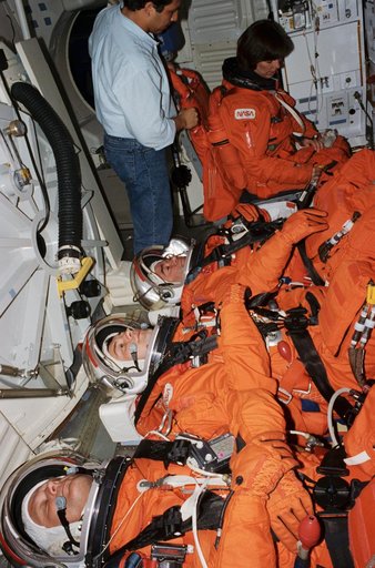 STS-71 cosmonauts and astronauts examine hardware to be flown on mission