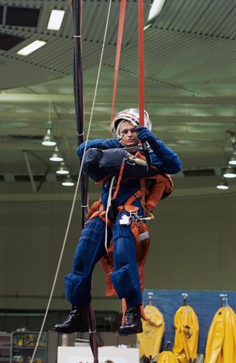 Cosmonaut Yuriy Onufriyenko simulates parachute drop into water