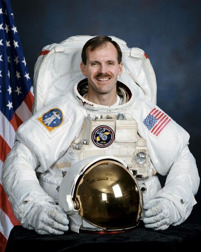 Official portrait of Astronaut Steve Smith wearing an EMU