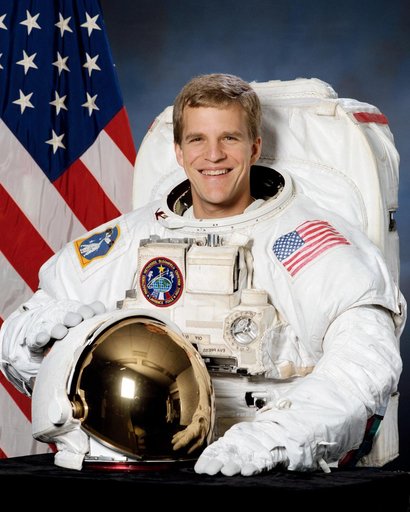 Official portrait of Scott Parazynski wearing EMU suit