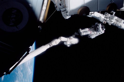 MS Hadfield works on the SSRMS during the first EVA of STS-100