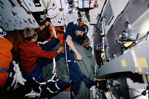 MS Guidoni and MS Parazynski in sleep restraints on the middeck of Endeavour during STS-100