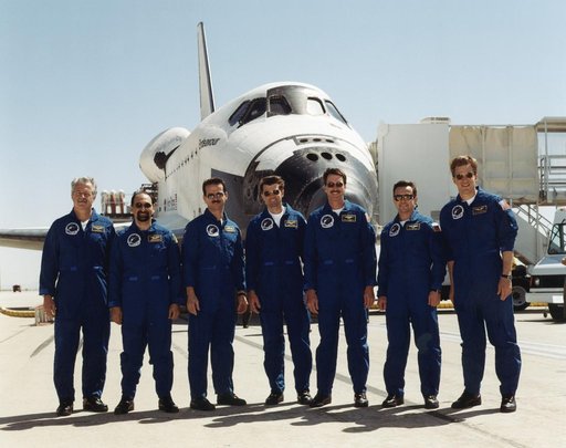The STS-100 crew pose in front of Endeavour after landing at Edwards AFB
