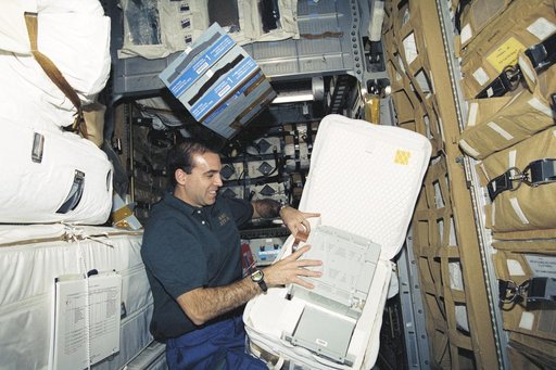 MS Mastracchio packs a battery in a stowage bag in SpaceHab during STS-106