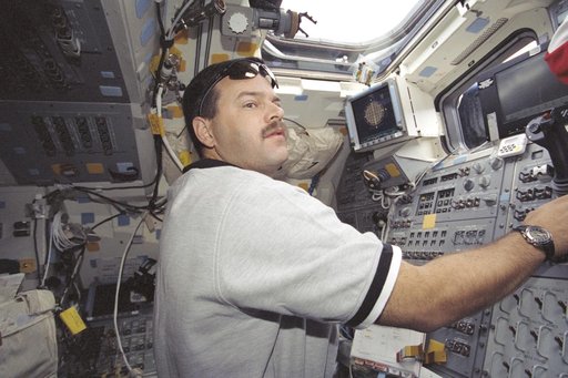Pilot Altman at the aft crew workstation during STS-106 undocking with ISS