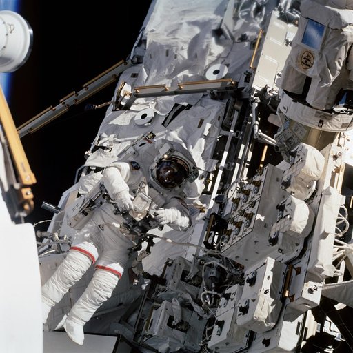 EVA 4 - MS Wolf works with Interface Umbilical Assembly on MT