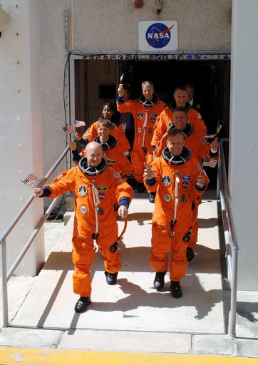 STS-121 crewmembers leave the O&C Bldg. on their way to the launch pad