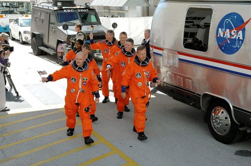 STS-121 crewmembers prepare to board transfer van at KSC