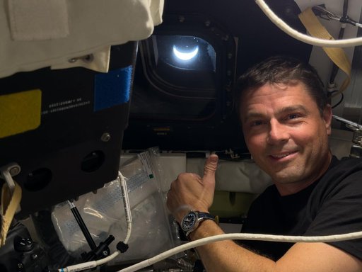 Reid Wiseman Poses With Earth in View