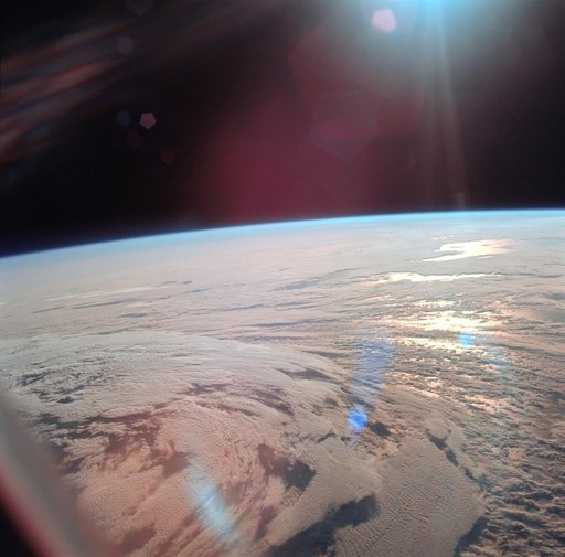 View of Earth showing clouds over water taken by Apollo 11 crewmembers
