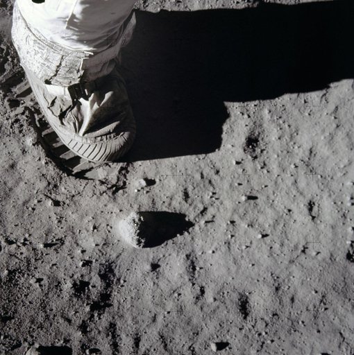 Close-up view of astronauts foot and footprint in lunar soil