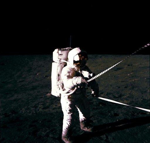 Astronaut Charles Conrad uses lunar equipment conveyer at Lunar Module