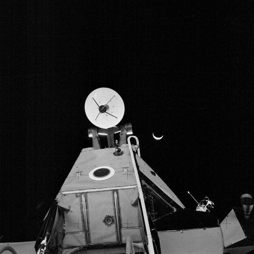 Apollo 14 Mission image - Dark view of an Earth crescent and the Lunar Module taken from the surface of the moon.