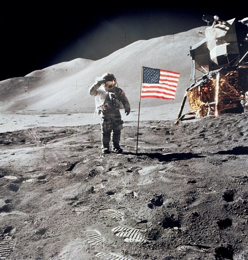 Astronaut David Scott gives salute beside U.S. flag during EVA