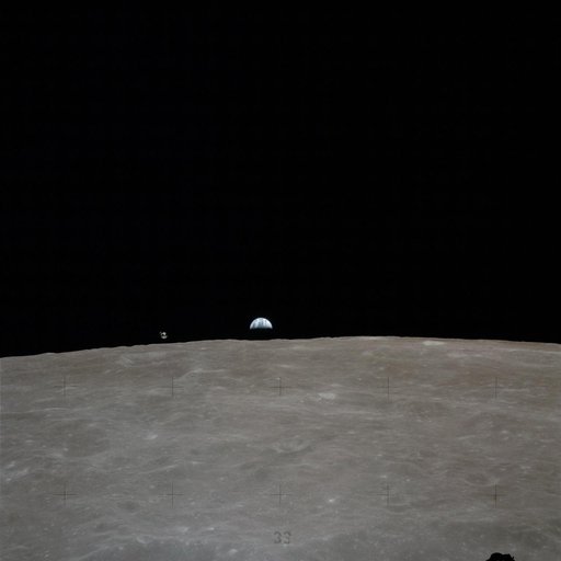 Apollo 16 Mission image - Earth rises over the lunar horizon, with the Apollo 16 Command and Services Modules (CSM) to the left of the Earth.